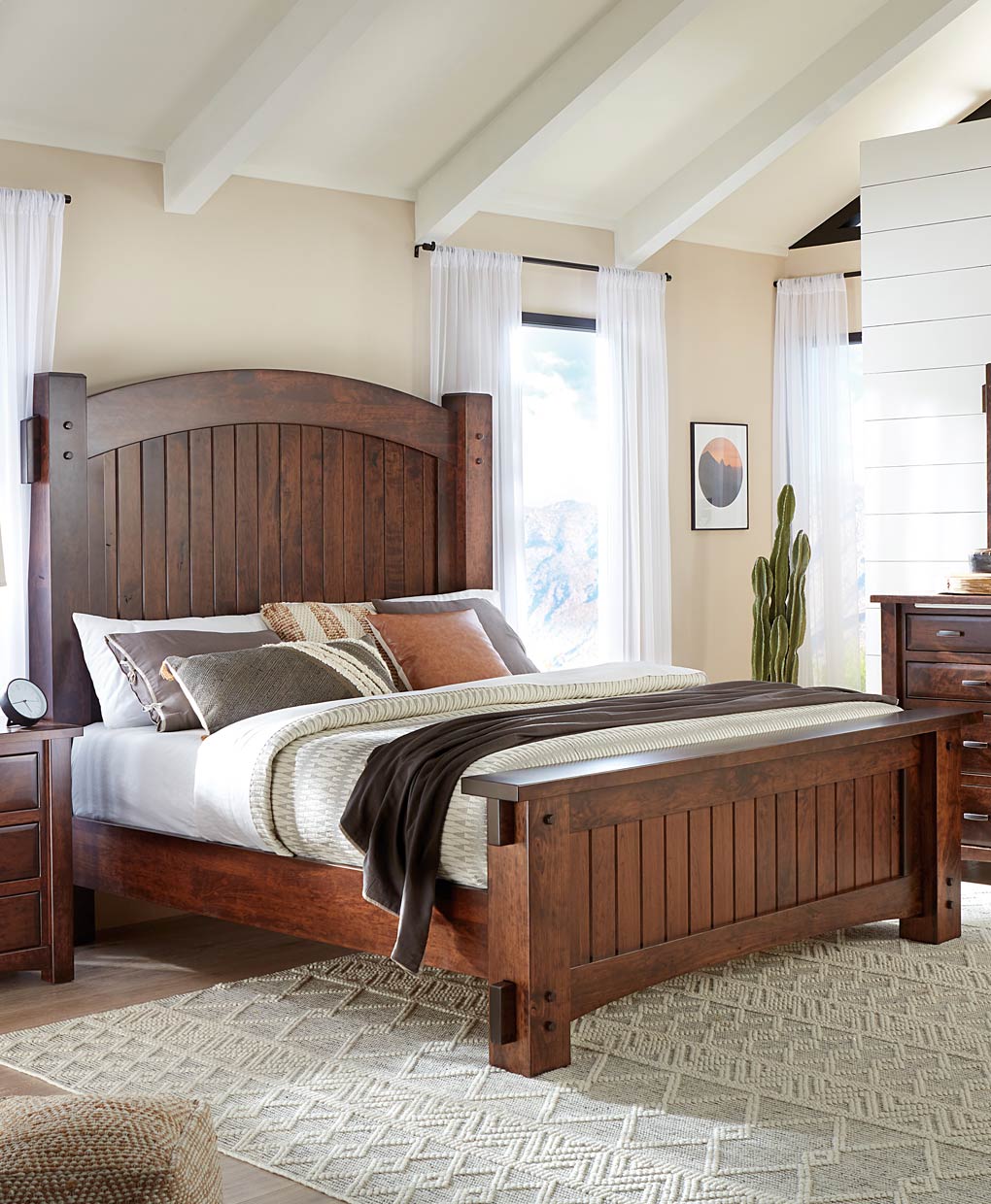 Wooden bed in a bedroom with a window and decor