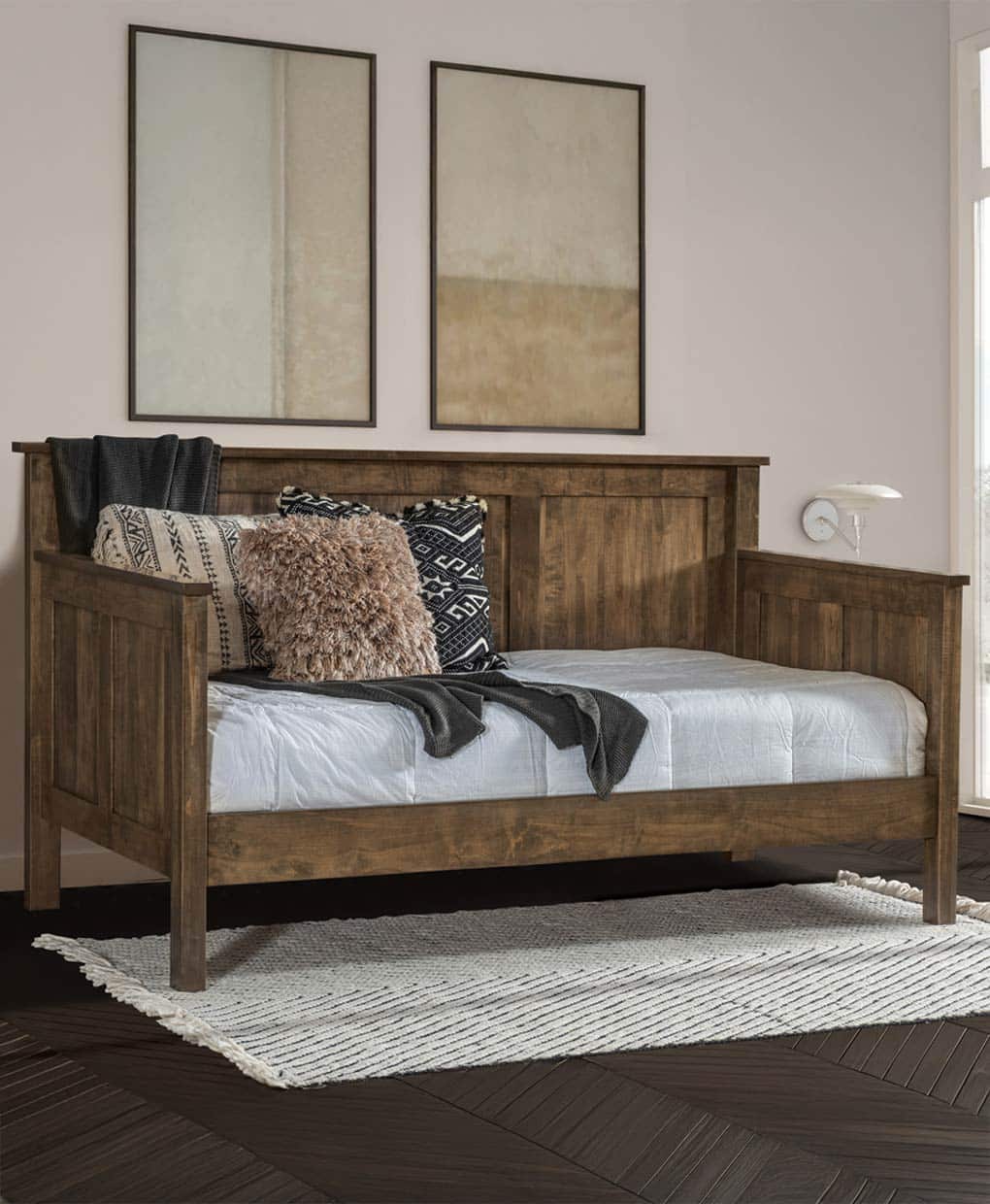 Wooden bed with pillows and blankets in a bedroom setting