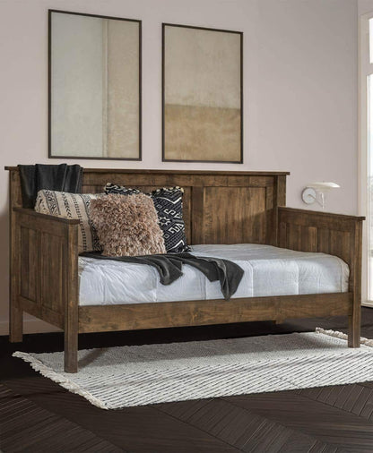 Wooden bed with pillows and blankets in a bedroom setting