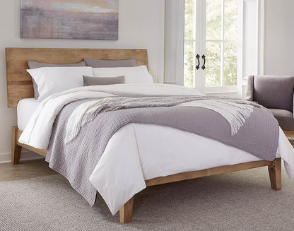Bedroom with wooden bed frame, white bedding, and gray throw blanket.