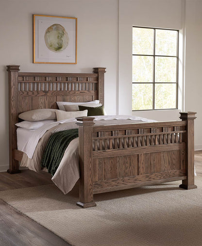 Wooden bed in a bedroom with a window and framed picture on the wall.