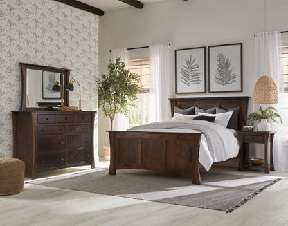 Bedroom with wooden furniture, including a bed, dresser, and mirror.