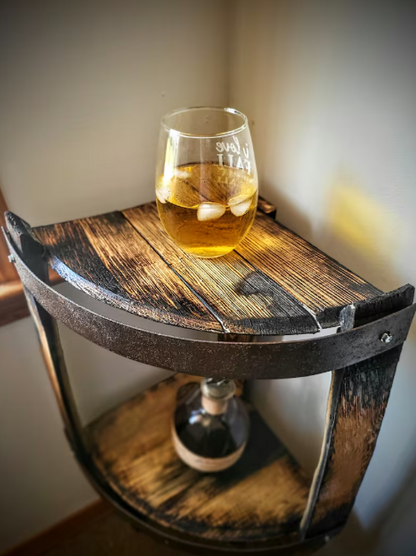 Wooden barrel side table with a glass of amber liquid on top